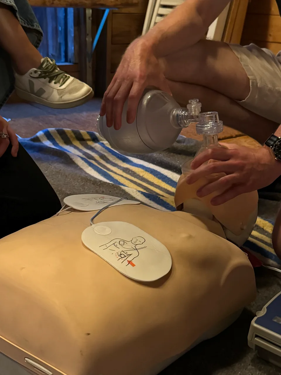 Erste-Hilfe-Übung mit Beatmungsbeutel und Defibrillator an der Übungspuppe